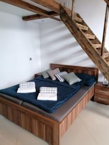 a bed with blue sheets and pillows in a room at Wiking in Turawa