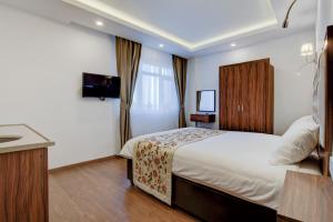 a bedroom with a large bed and a large window at Violin Boutique Hotel in Istanbul