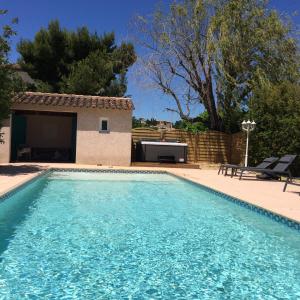 a swimming pool in front of a house at Castel Mireio in Cairanne