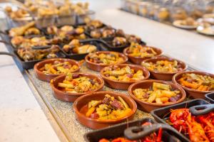 a bunch of food in small dishes on a table at RVHotels Nieves Mar in L'Escala