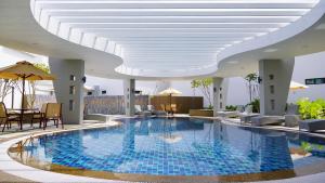 a swimming pool in a hotel with a white ceiling at Raia Hotel & Convention Centre Alor Setar in Alor Setar