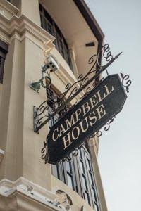 a street sign on the side of a building at Campbell House in George Town