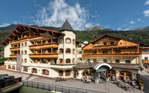 a large building with a lot of windows at Alpinresort Stubaierhof ****s in Fulpmes