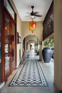 a hallway with a tile floor in a building at Campbell House in George Town