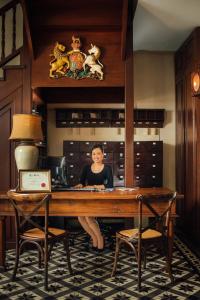 a woman sitting at a desk in a room at Campbell House in George Town