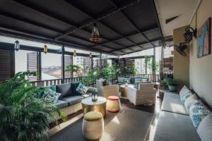 a living room with couches and tables and plants at Campbell House in George Town