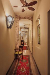 a hallway with a ceiling fan and a rug at Campbell House in George Town