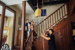 a group of people on the stairs of a house at Campbell House in George Town
