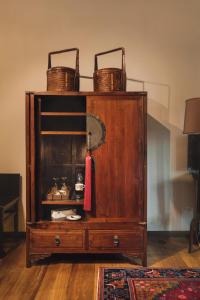 a wooden cabinet with baskets on top of it at Campbell House in George Town