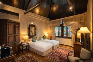 a bedroom with two beds and a television in it at Campbell House in George Town