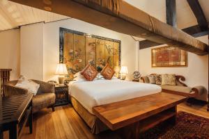 a bedroom with a large bed and a couch at Campbell House in George Town