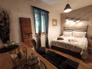 a bedroom with a bed and a table with a table sidx sidx at Bed & Breakfast SENTIERO 54 in Cantiano