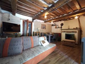 a living room with a couch and a fireplace at Bed & Breakfast SENTIERO 54 in Cantiano