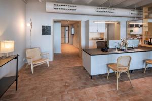 an office with a counter and chairs and a hallway at GHT Miratge - Only Adults 18 and up in Lloret de Mar