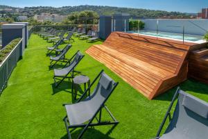 a row of chairs on the roof of a building at GHT Sa Riera in Tossa de Mar