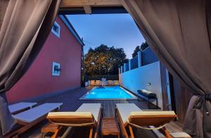 a view of a swimming pool from the balcony of a house at Villa with a heated Pool near Split with Magnificent View in Solin