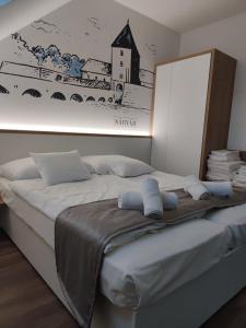 Posteľ alebo postele v izbe v ubytovaní Androméda Apartman