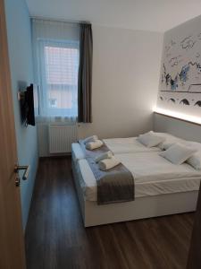 Posteľ alebo postele v izbe v ubytovaní Androméda Apartman