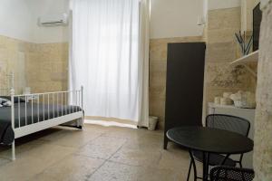 Postel nebo postele na pokoji v ubytování Donato Rooms