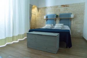 מיטה או מיטות בחדר ב-Donato Rooms