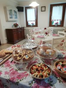 a table with many plates of food on it at B&B La casa di Loretta in Paderno