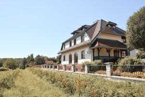 a large house with a fence in a field at Quo Vadis Lounge Bed & Breakfast in Kazimierz Dolny +7 photos