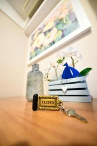 un llavero sentado en una mesa junto a una botella en Hotel Eliseo Riccione, en Riccione