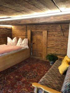 a room with two beds and a couch in it at Wölzenberg Alm in Reith im Alpbachtal