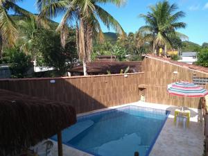 a view of the pool from the house at Residencial Villa Nova SUITE in Boicucanga