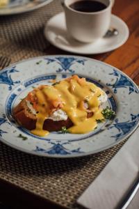 a plate with a piece of bread with cheese on it at Campbell House in George Town