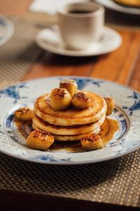 a plate with a stack of pancakes on a table at Campbell House in George Town