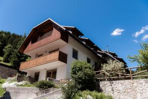 a house with a balcony on the side of it at Tromeja in Rateče