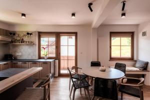 a kitchen with a table and chairs in a room at Tromeja in Rateče