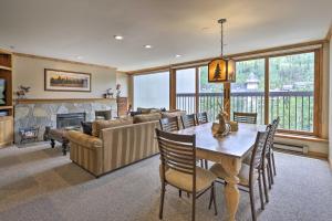 a living room with a table and a couch and a fireplace at Spacious Vail Condo Steps From Eagle Bahn Gondola in Vail