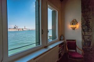 a window with a view of the water at Giudecca Apartment in Venice