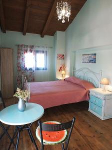 a bedroom with a large bed and a table and chairs at Maria GuestHouse in Aliveri