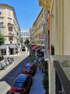 a city street with cars parked on the sidewalk at Hotel Boréal Nice in Nice