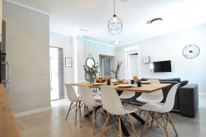 a dining room and living room with a table and chairs at Tony's house with private pool, garden and parking in Zadar