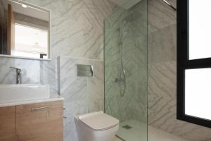 a bathroom with a shower and a toilet and a sink at Avalon 1 Villa 14 in Paphos