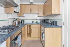 a kitchen with a sink and a stove top oven at Cosy One Bedroom Apartment in Worcester