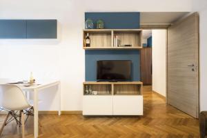 a living room with a tv and a table at Contempora Apartments - Cavallotti 13 - B22 in Milan