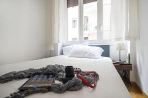 a bedroom with a bed with a laptop on it at Contempora Apartments - Cavallotti 13 - B22 in Milan