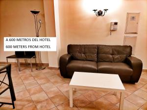 
a living room with a couch and a table at Abadía Hotel in Granada

