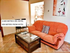 a living room filled with furniture and a couch at Abadía Hotel in Granada