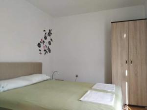 a bedroom with a bed and a wooden cabinet at Apartman Natura vita Blagaj in Blagaj +50 photos