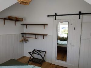 a room with a mirror and a bedroom with a bed at Ferienwohnung Kleiner Onkel in Uhldingen-Mühlhofen