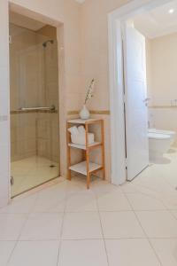 a bathroom with a shower and a toilet and a sink at Stella Stays Magnificent 4 BDR Palm Villa Beach Private Pool in Dubai