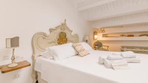 a hotel room with a bed, desk, and mirror at Addimora Boutique Suites in Palermo