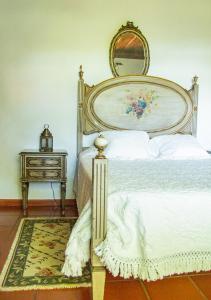 a bedroom with a bed and a table with a mirror at Casa da Quinta do Outeiro in Viana do Castelo +24 photos