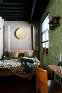 a bedroom with two beds and a table and a window at B&B Villa Thibault in Liège